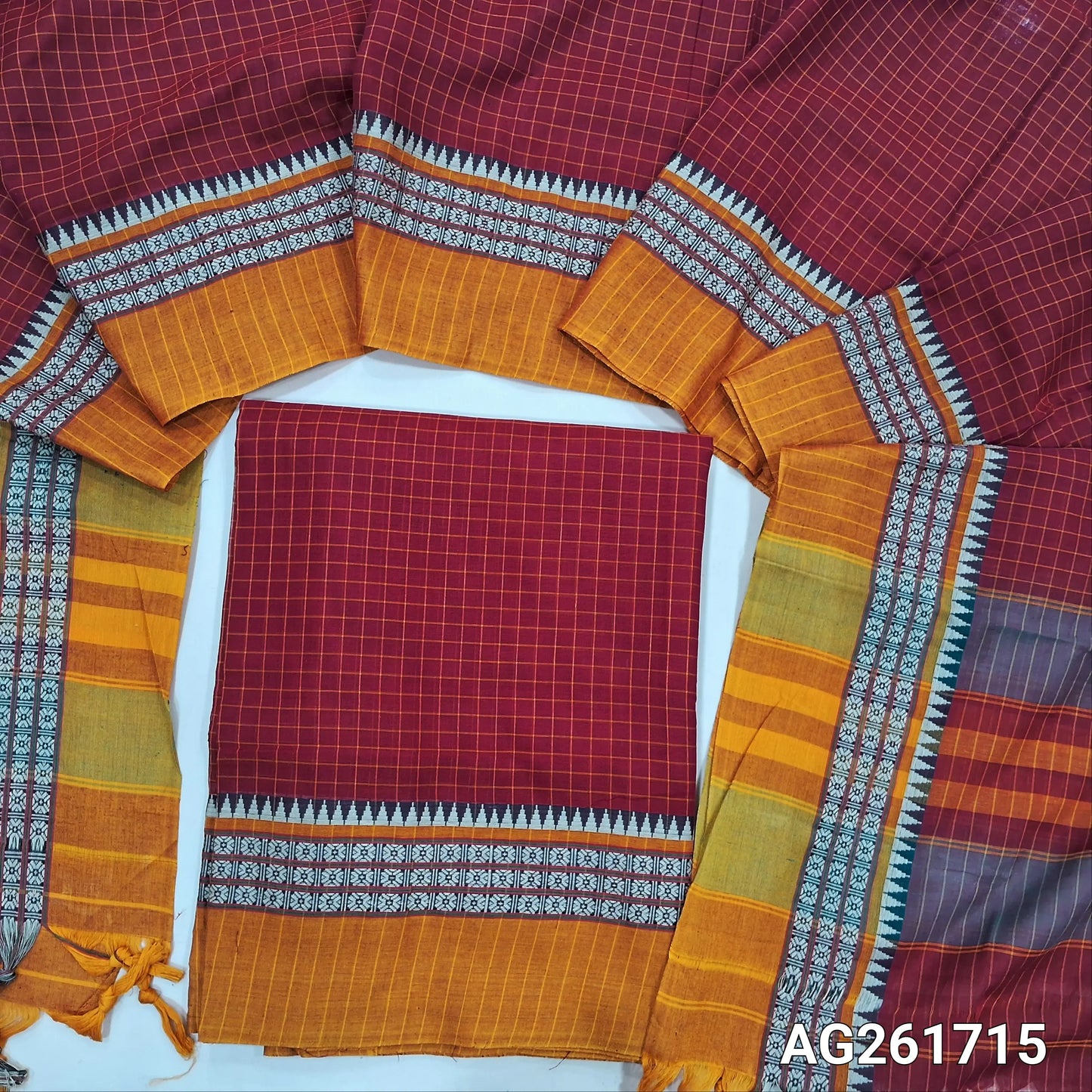 Red mercerized handloom cotton unstitched salwar material(thin, lining needed) checked all over with contrast traditional thread woven border, bottom included with top, checked mercerized handloom cotton dupatta with borders and tassels. AG261715