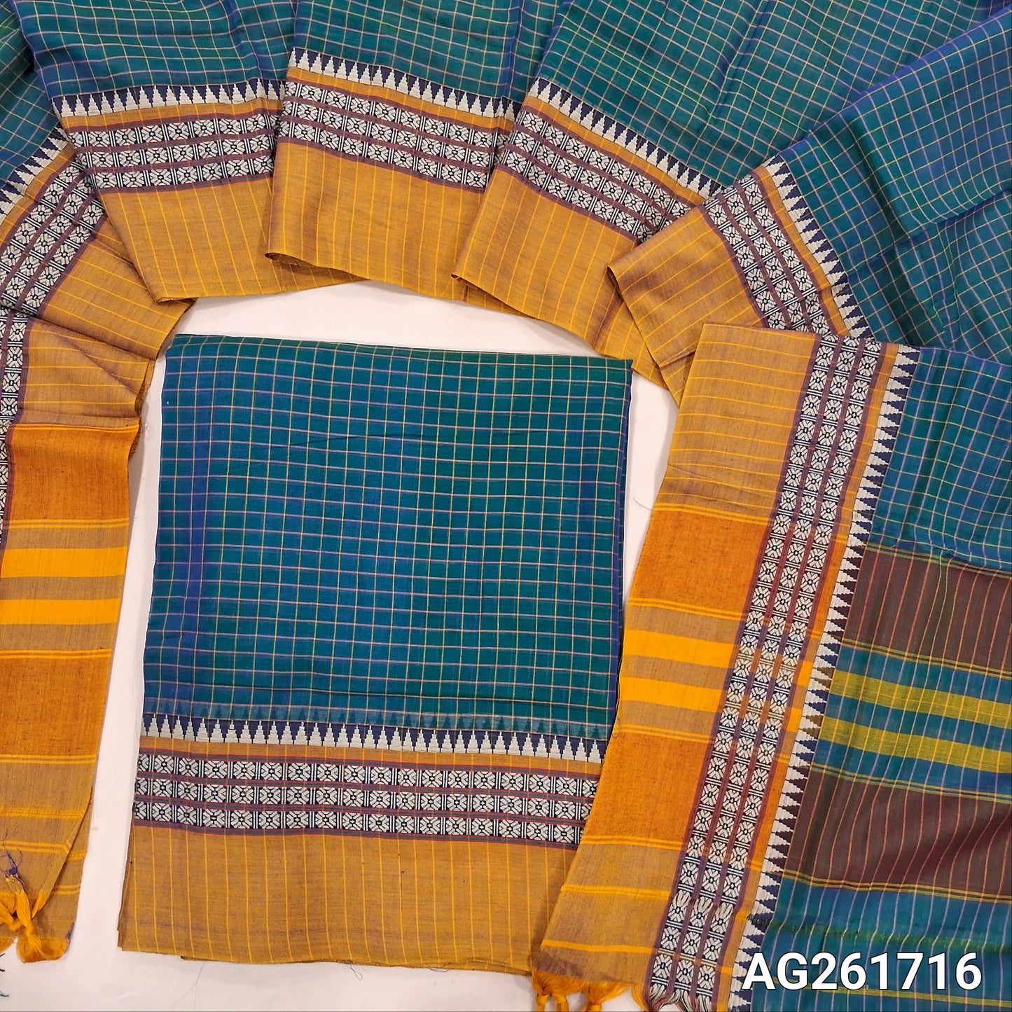 Teal blue mercerized handloom cotton unstitched salwar material(thin, lining needed) checked all over with contrast traditional thread woven border, bottom included with top, checked mercerized handloom cotton dupatta with borders and tassels. AG261716