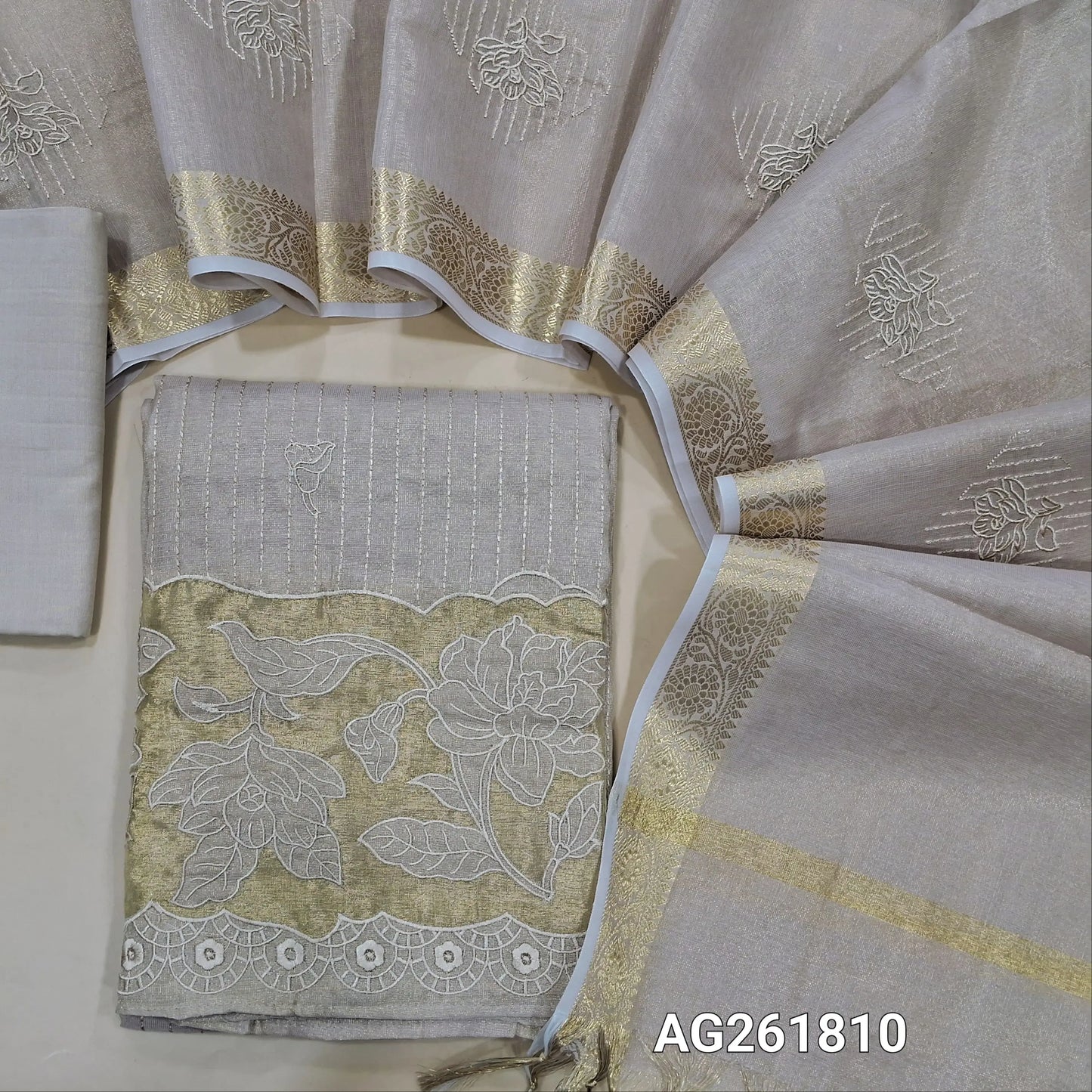 Golden beige with pink tint tissue silk cotton unstitched salwar material, vertical embroidery & floral design,tissue daman with applique work (lining needed) spun cotton bottom, floral embroidered tissue silk cotton dupatta with zari borders. AG261810