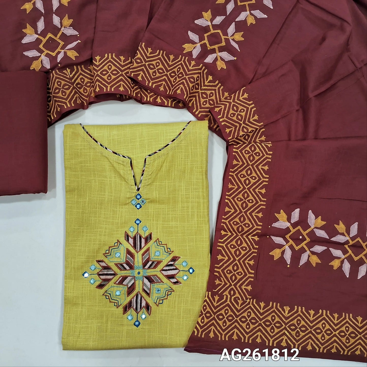 Pastel yellow premium slub cotton unstitched salwar material, applique and faux mirror on yoke( soft,lining needed)reddish maroon cotton bottom,premium hand block printed mul cotton dupatta. AG261812