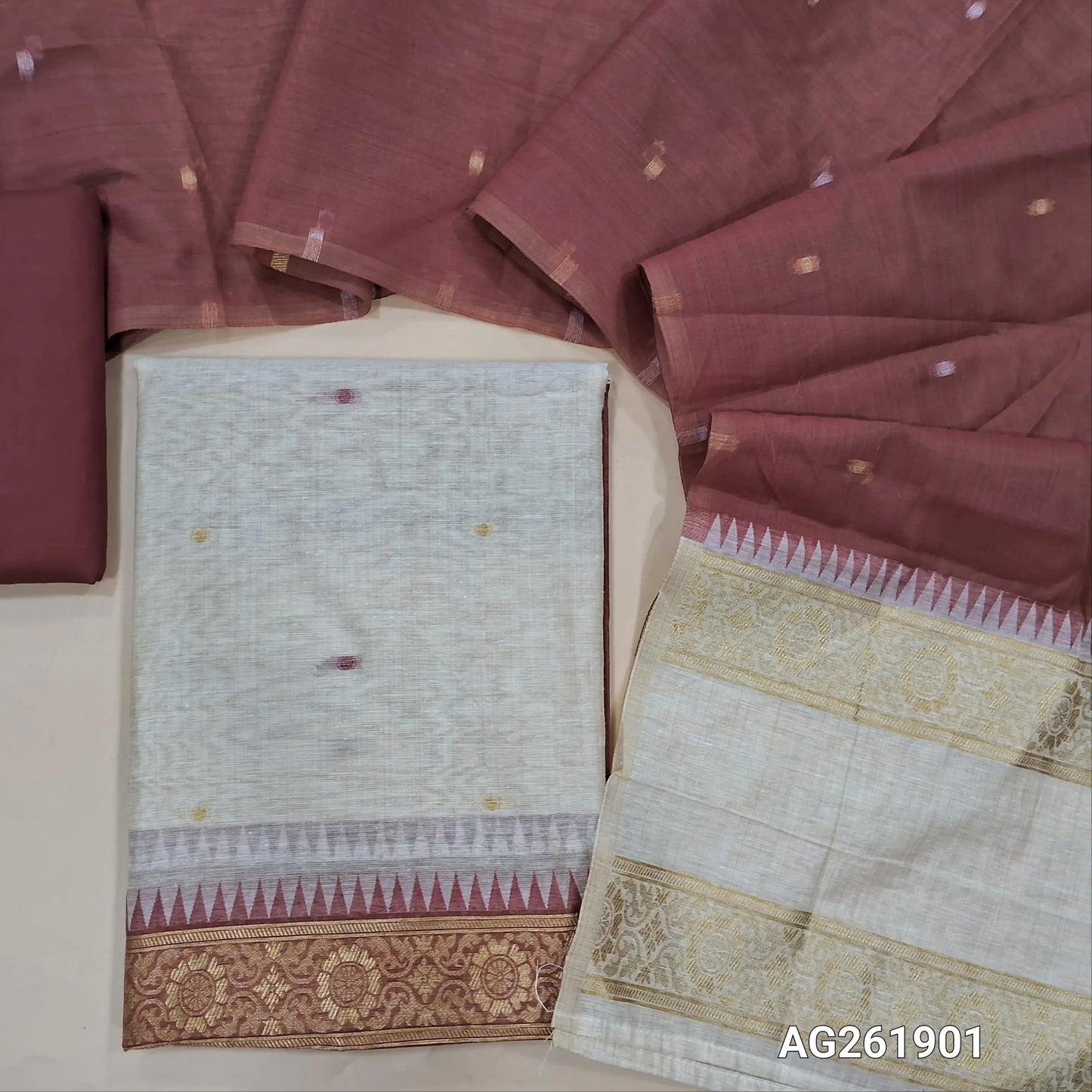 Off white silk cotton unstitched salwar material,contrast yoke with zari weaving border, gap border on daman,(Lining Needed)maroon spun cotton bottom, silk cotton dupatta with contrast pallu with gap borders. AG261901