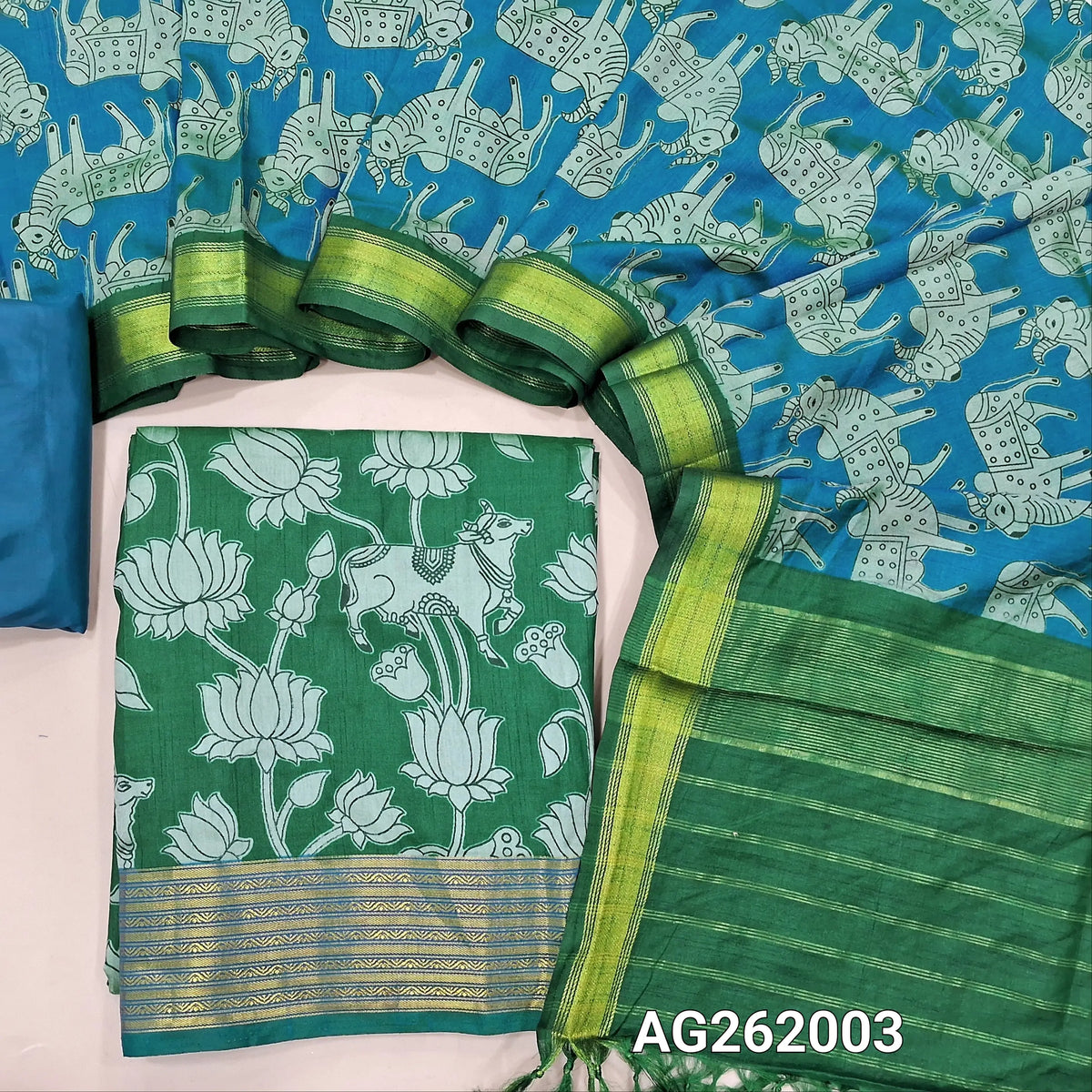 Turquoise green premium silk unstitched salwar material, pichwai printed all over,(silky,lining needed)royal blue silky bottom, dual shaded pichwai printed premium silk dupatta with contrast pallu and tassles. AG262003