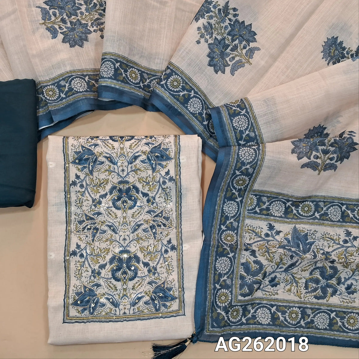 Off white base semi linen unstitched salwar material,floral printed  with zari & sequins on yoke,zari woven buttas and printed all over,(thin, lining needed)dark teal blue silky bottom,floral printed semi linen dupatta. AG262018