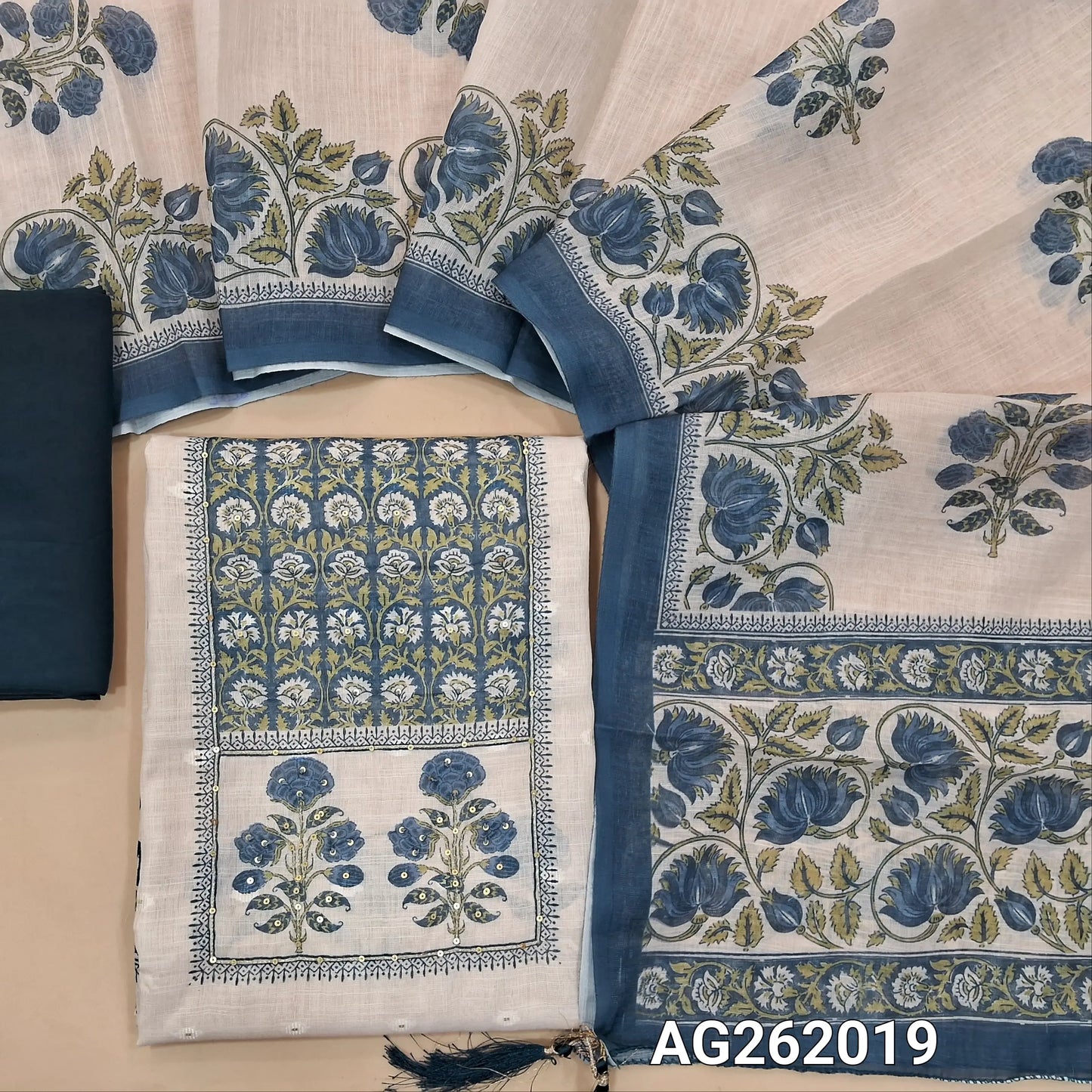 Off white base semi linen unstitched salwar material,floral printed  with zari & sequins on yoke,zari woven buttas and printed all over,(thin, lining needed)dark teal blue silky bottom,floral printed semi linen dupatta. AG262019