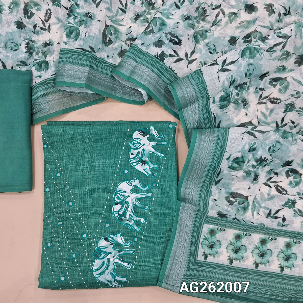 Turquoise blue semi linen unstitched salwar material,v neck with applique work, kantha stitch & foil work( lining optional)santoon bottom,floral printed semi linen dupatta with silver tissue borders. AG262007