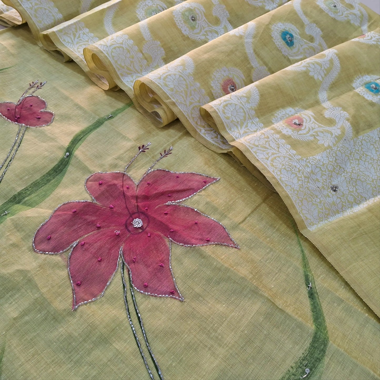 Pastel Yellow premium muga silk cotton unstitched salwar material, hand brush paint work on front with cut bead detailing (Lining Needed) matching santoon bottom, rich jamdani and meenakari woven muga silk cotton dupatta with cut bead work. AG262202