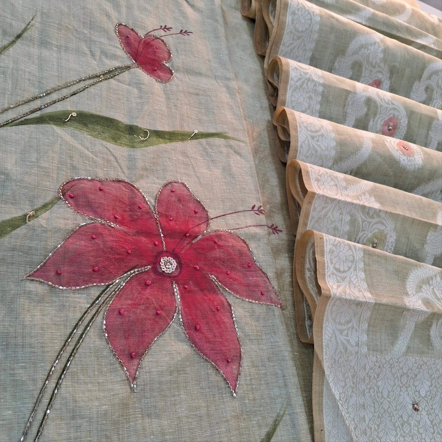 Light grey premium muga silk cotton unstitched salwar material, hand brush paint work on front with cut bead detailing (Lining Needed) matching santoon bottom, rich jamdani and meenakari woven muga silk cotton dupatta with cut bead work. AG262204