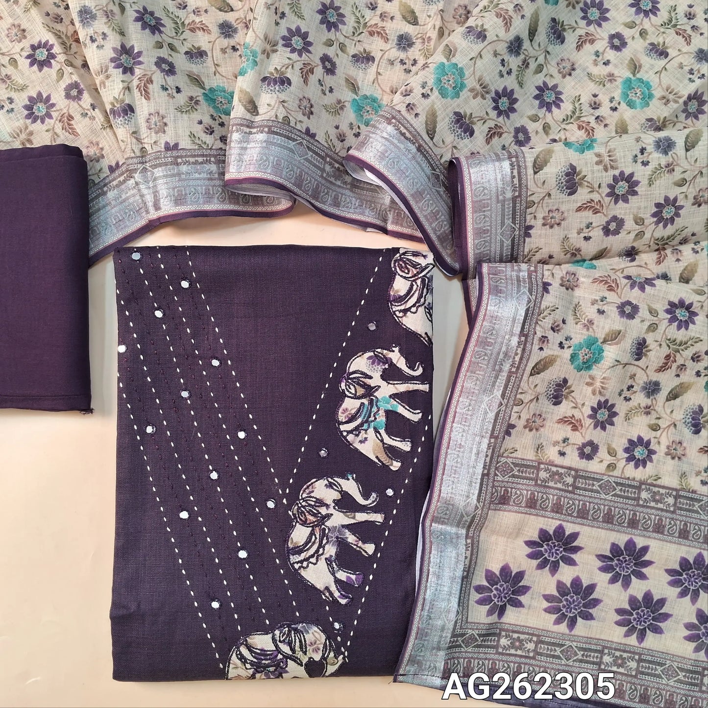 Deep wine purple semi linen unstitched salwar material, V neckline with kantha, foil and applique work (Lining Optional) matching santoon bottom, semi linen floral printed dupatta with silver tissue borders. AG262305