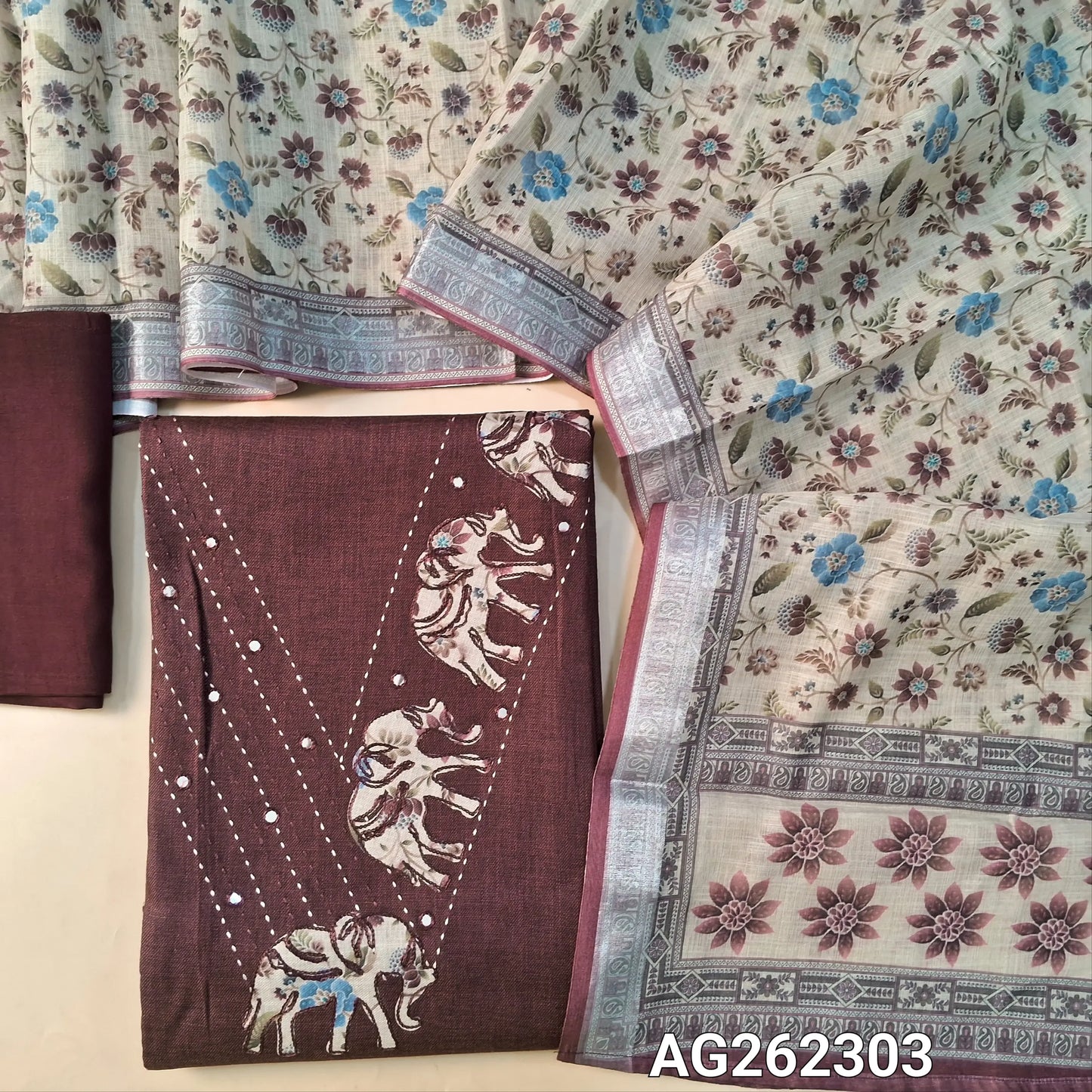 Dark Maroon semi linen unstitched salwar material, V neckline with kantha, foil and applique work (Lining Optional) matching santoon bottom, semi linen floral printed dupatta with silver tissue borders. AG262303
