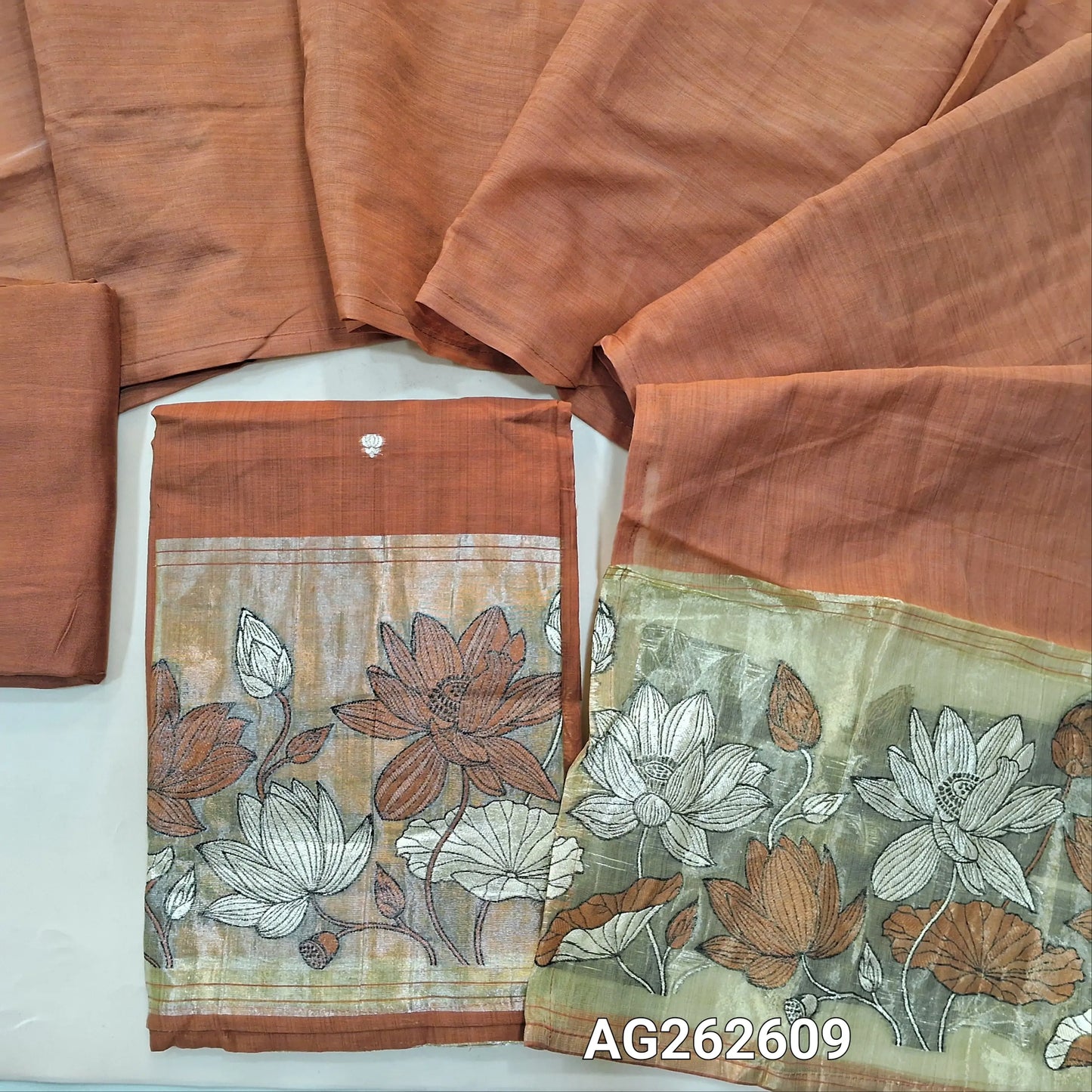 Dark Peach fancy silk cotton unstitched salwar material, gold tissue daman with embroidery and zari weaving, small zari buttas on front (Lining Needed) matching bottom, silk cotton dupatta with weaving on pallu. AG262609