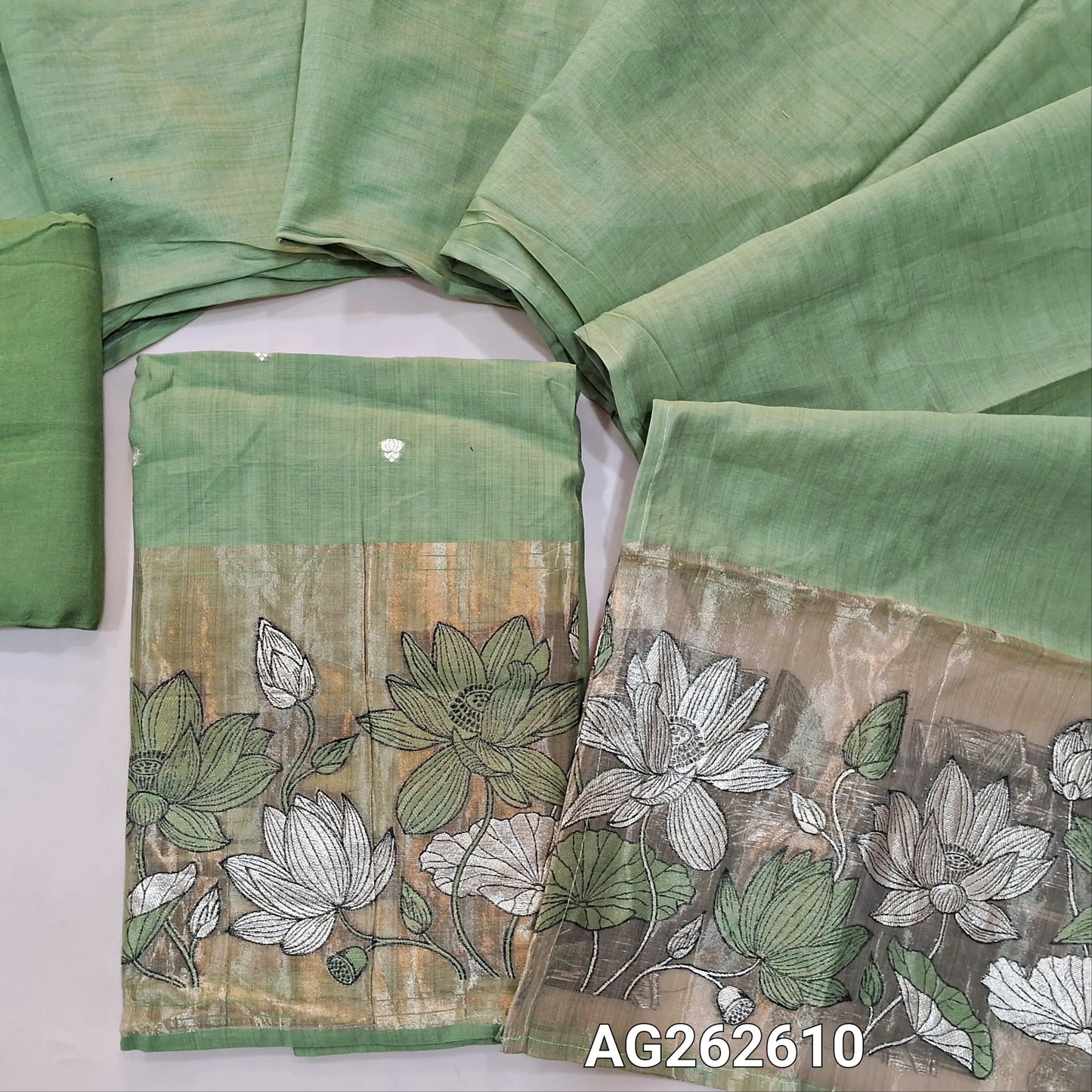 Sage green fancy silk cotton unstitched salwar material, gold tissue daman with embroidery and zari weaving, small zari buttas on front (Lining Needed) matching bottom, silk cotton dupatta with weaving on pallu. AG262610