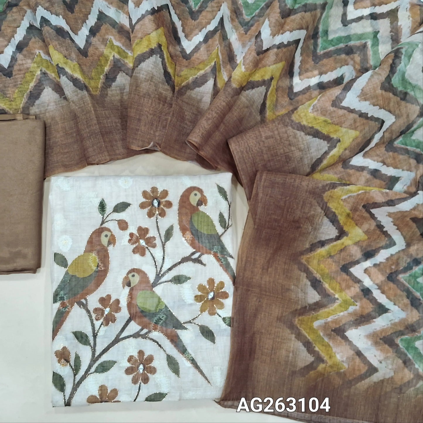 Beige and brown digital printed lightweight silk cotton unstitched salwar material, thread and silver zari woven buttas all over (Thin, Lining Needed) Matching santoon bottom, multicolored digital printed silk cotton dupatta. AG263104
