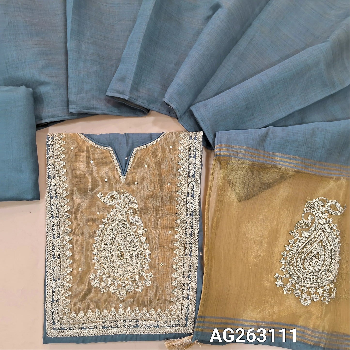 Blue designer premium silk cotton unstitched salwar material, rich tissue yoke with embroidery and zari detailing, zari woven buttas all over, tissue daman (Lining Needed) Matching Bottom, Silk Cotton dupatta with rich pallu. AG263111
