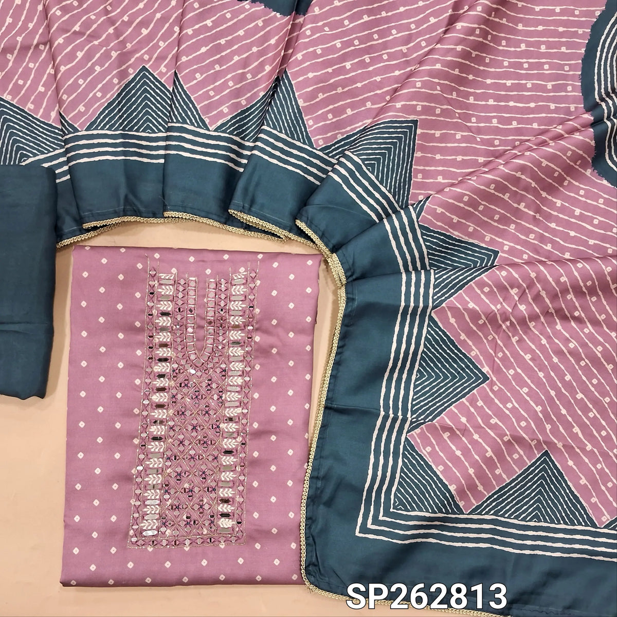 Pastel pink pure gaiji silk unstitched salwar material, bandhini printed all over,real mirror and thread work on yoke, (HEAVY FABRIC)dark teal blue santoon bottom, printed gaiji silk dupatta with tapping. SP262813