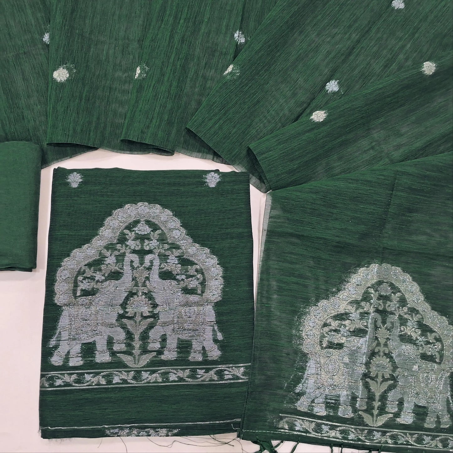 Bottle Green tussar unstitched salwar material with rich gold and silver jamdani weaving on yoke and daman (Thin, Lining Needed) Matching  santoon Bottom, jamdani woven tussar dupatta with handmade tassels. SP260214