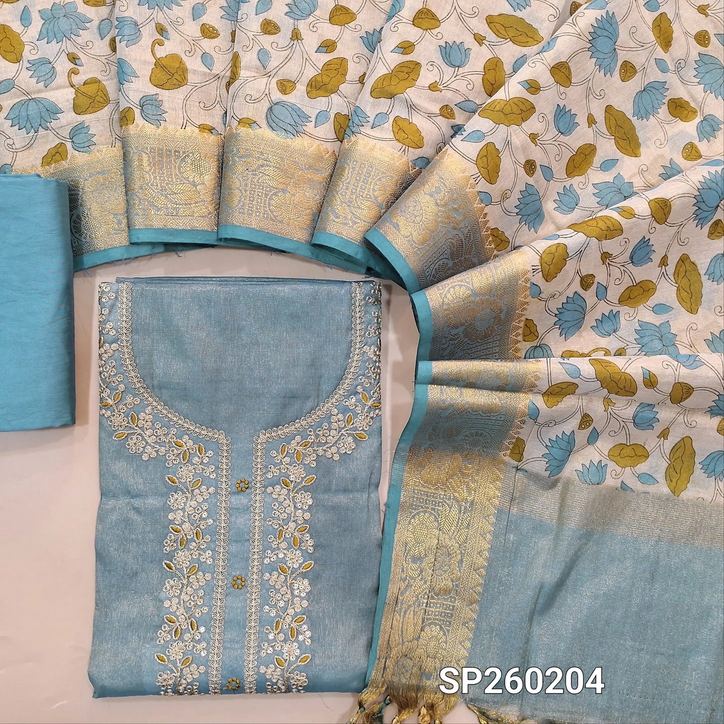 Blue with golden tint tissue silk cotton unstitched salwar material, embroidery and zari thread weaving on yoke (Lining Needed) Matching Silky Bottom, digital printed tissue silk cotton dupatta with benarasi zari woven borders. SP260204