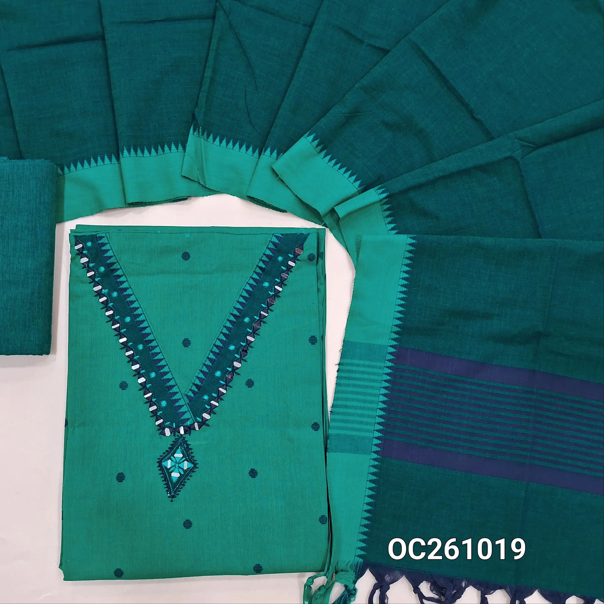 Turquoise green premium handloom cotton unstitched salwar material,thread woven buttas on front, v neck with real mirror on yoke, (lining optional) teal green handloom cotton bottom,handloom cotton dupatta with contrast borders. OC261019