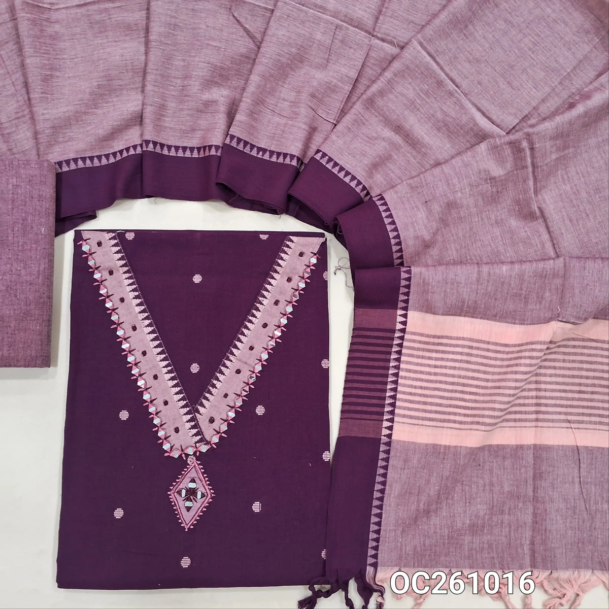 Dark purple premium handloom cotton unstitched salwar material,thread woven buttas on front, v neck with real mirror on yoke, (lining optional)pastel pink handloom cotton bottom,handloom cotton dupatta with contrast borders. OC261016