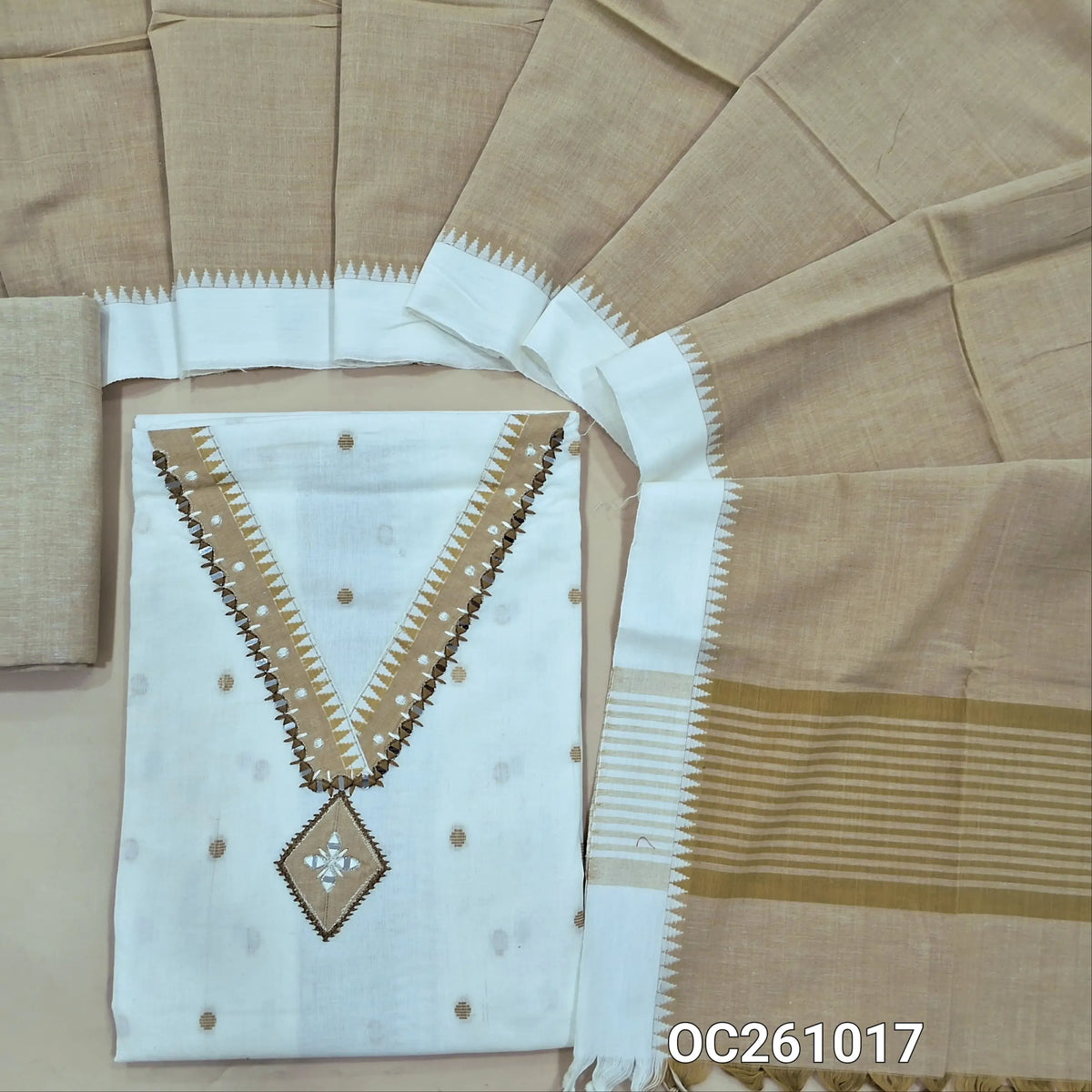 Off white premium handloom cotton unstitched salwar material,thread woven buttas on front, v neck with real mirror on yoke, (lining optional)beige handloom cotton bottom,handloom cotton dupatta with contrast borders. OC261017