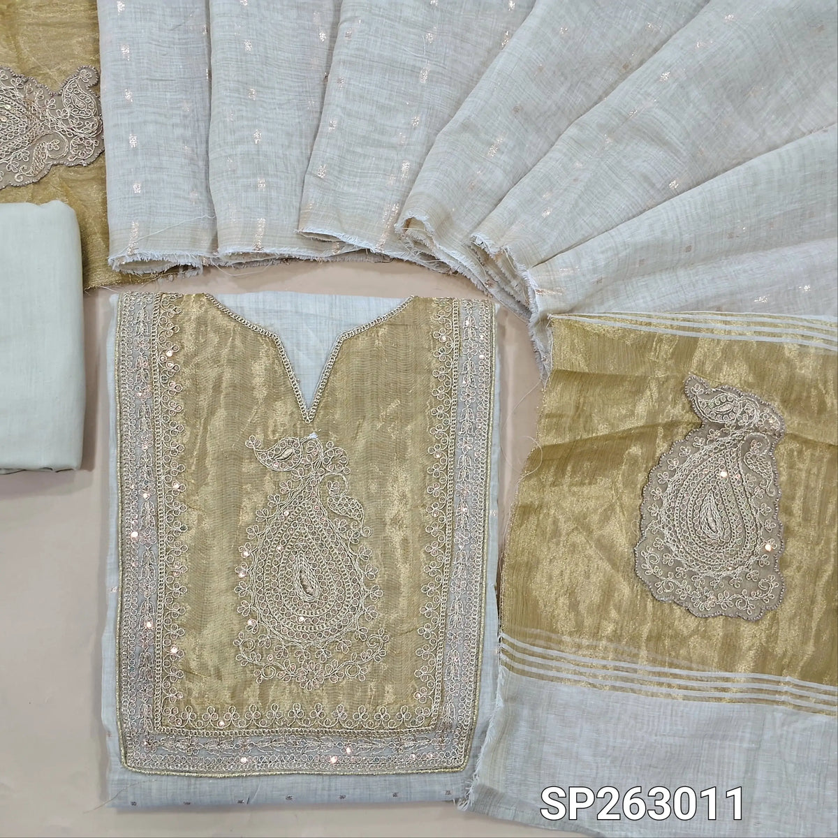 Light beige silk cotton unstitched salwar material,tissue fabric on yoke with zarodzi, zari and sequins work, zari buttas all over,( Lining Needed) cotton bottom,buttas on silk cotton dupatta with rich pallu. SP263011