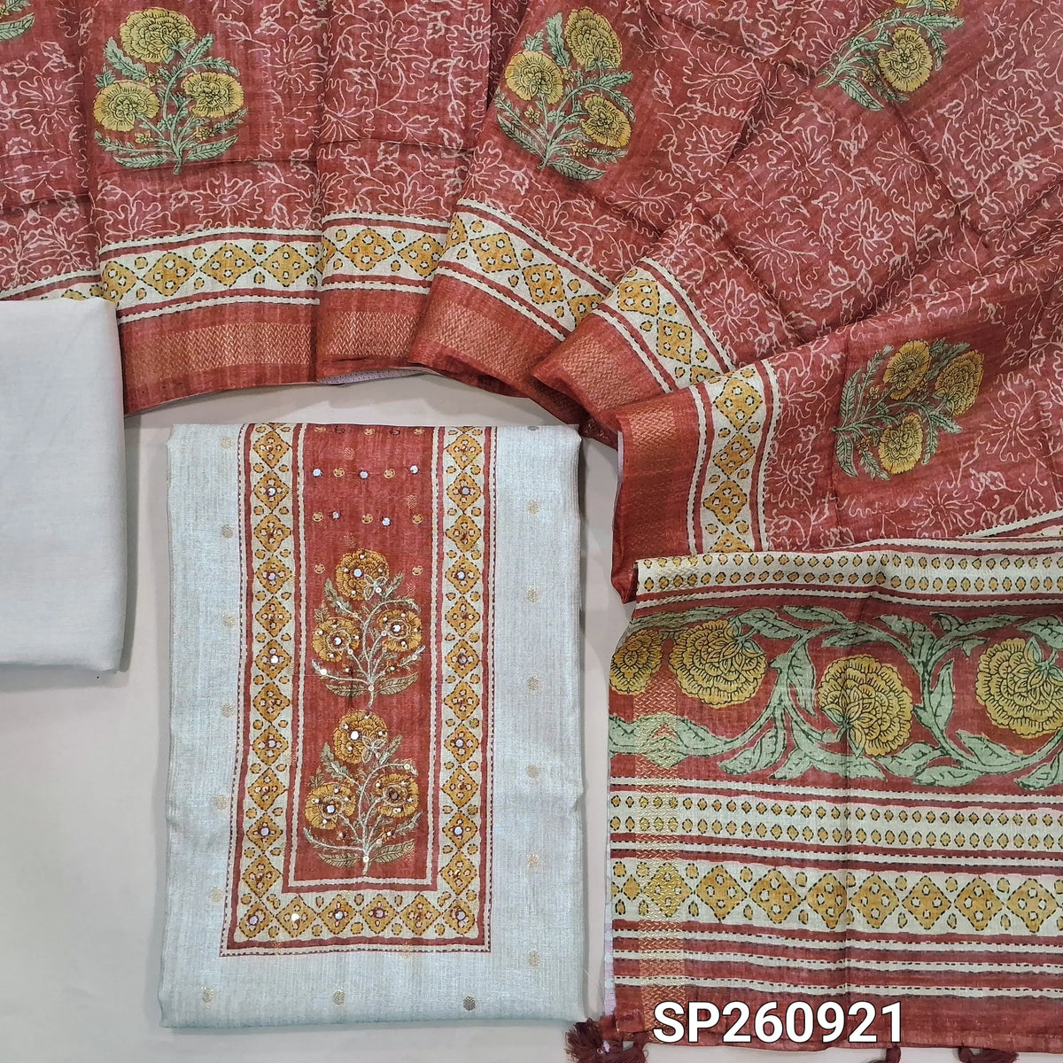 Beige and red premium tussar silk unstitched salwar material, zari buttas on front, contrast yoke (Lightweight, Lining Needed)matching spun cottob bottom, digital printed premium tussar dupatta. SP260921