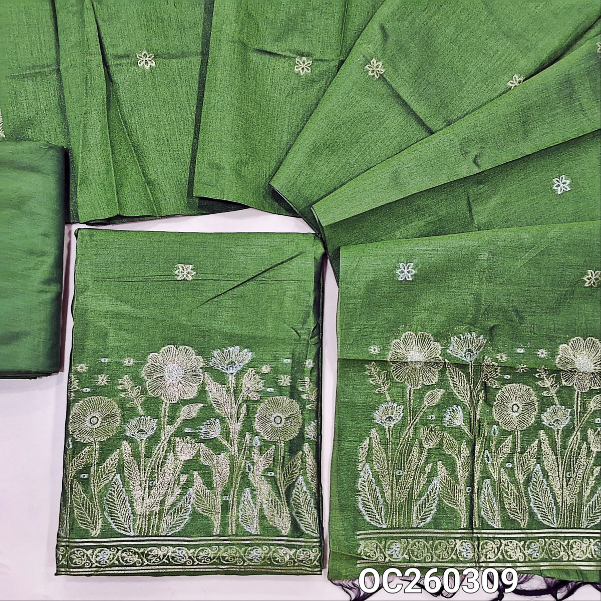 Leafy green premium silk cotton unstitched salwar material, buttas on front,antic gold and silver zari on daman,(lining needed)silky bottom,buttas on full length silk cotton dupatta with rich pallu. OC260309