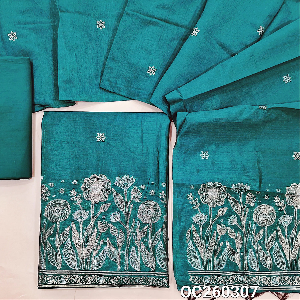 Bright turquoise blue premium silk cotton unstitched salwar material, buttas on front,antic gold and silver zari on daman,(lining needed)silky bottom,buttas on full length silk cotton dupatta with rich pallu. OC260307