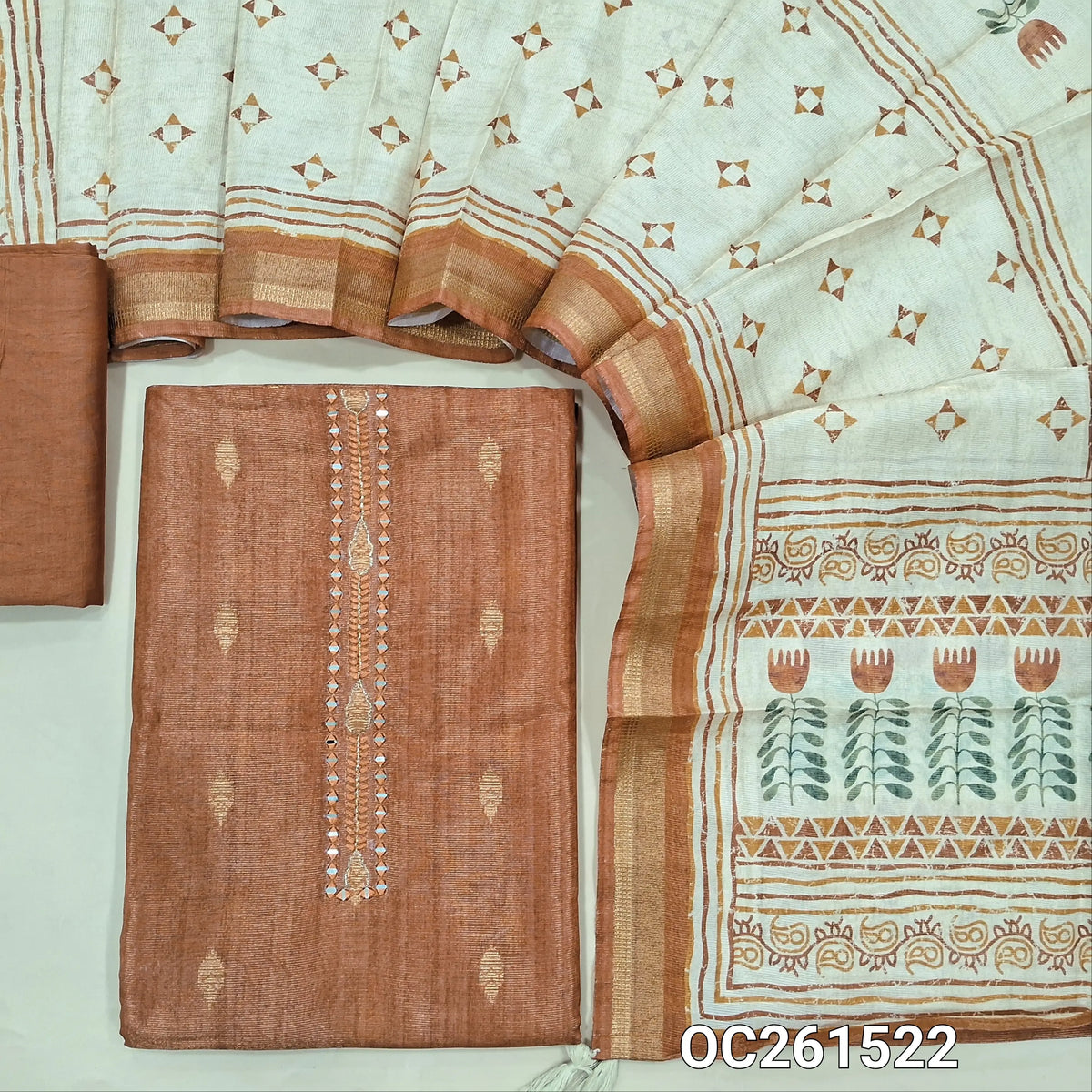 Brick red with golden tint tissue silk cotton unstitched salwar material, real mirror yoke, copper zari buttas all over,(lining needed)silky bottom, digital printed soft tissue silk cotton dupatta with zari borders. OC261522