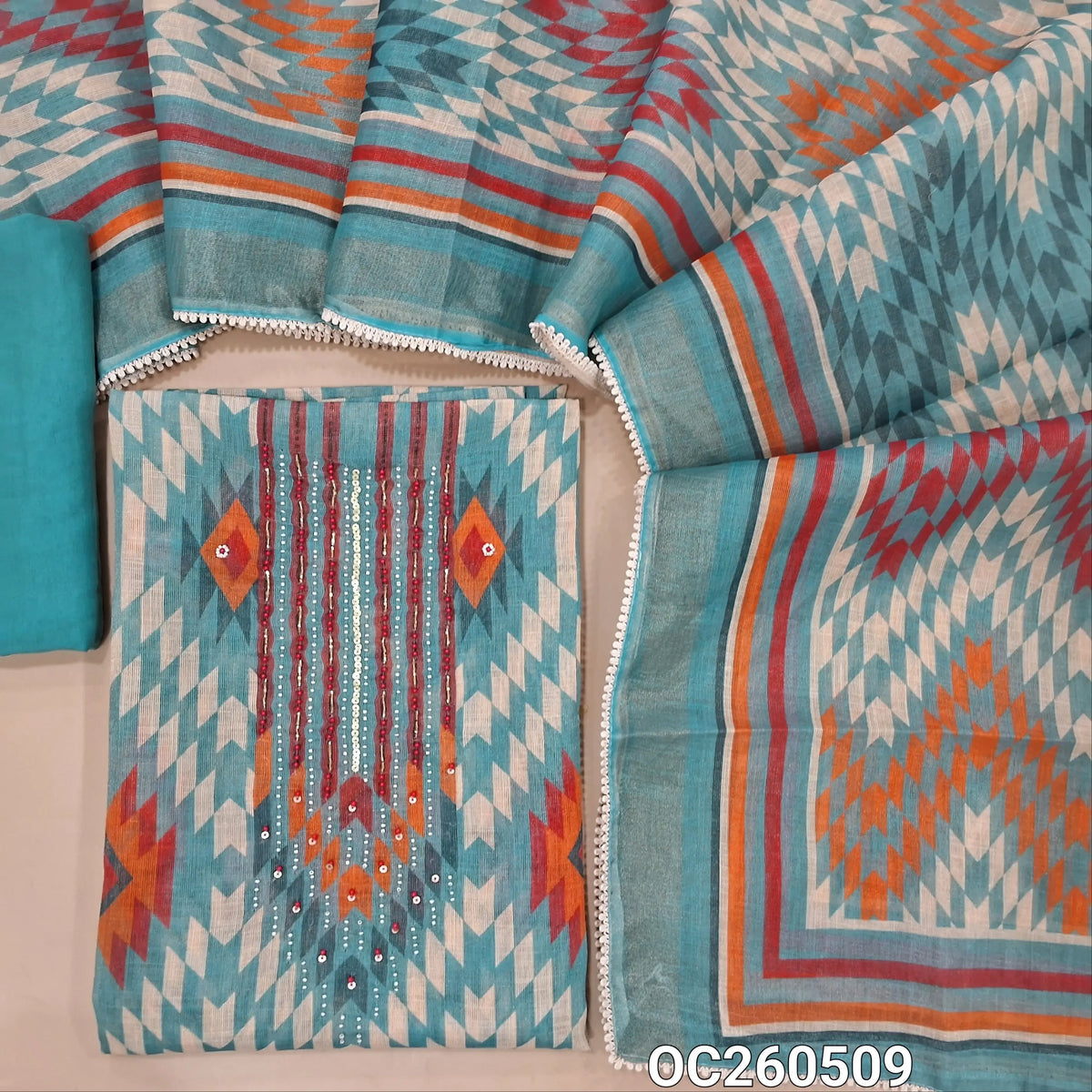 Pastel blue with golden tint tissue linen unstitched salwar material,bead, sequins and zardosi on yoke,printed all over,( lining needed)santoon bottom,printed tissue linen dupatta with lace tapping. OC260509