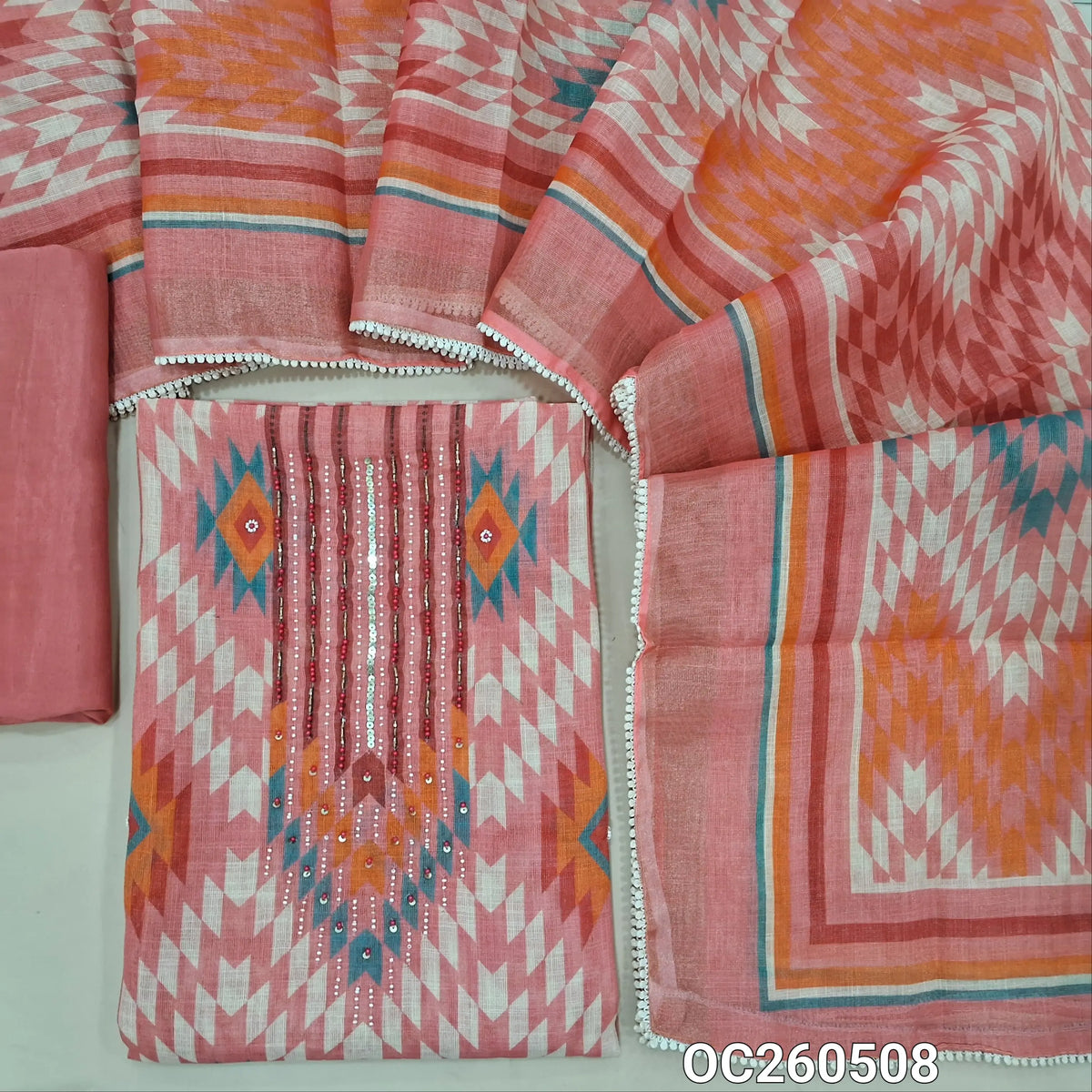 Pastel pink with golden tint tissue linen unstitched salwar material,bead, sequins and zardosi on yoke,printed all over,( lining needed)santoon bottom,printed tissue linen dupatta with lace tapping. OC260508