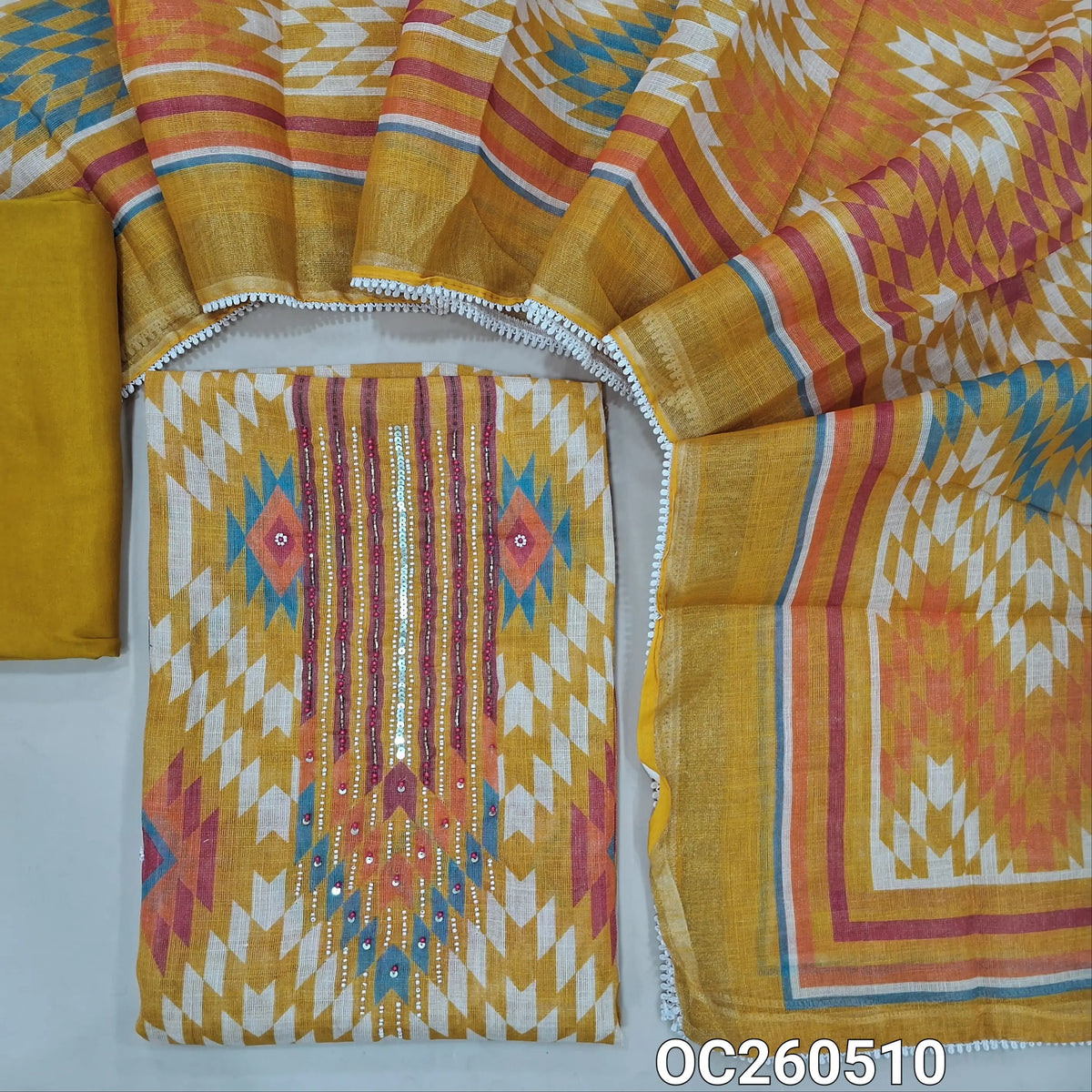 Mehandhi yellow with golden tint tissue linen unstitched salwar material,bead, sequins and zardosi on yoke,printed all over,( lining needed)santoon bottom,printed tissue linen dupatta with lace tapping. OC260510