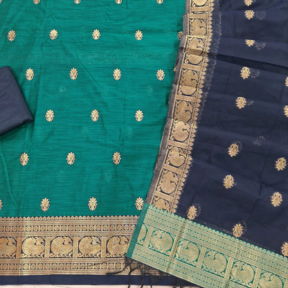Teal blue premium silk cotton unstitched salwar material,buttas all over benarasi zari weaving daman, (lining needed)dark blue silky bottom,buttas on silk cotton dupatta with pallu and borders. SP261805