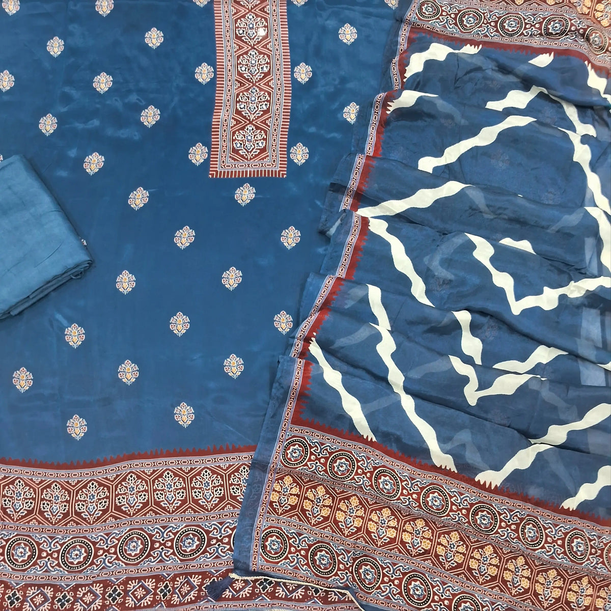 Indigo blue crepe silk unstitched salwar material, printed yoke with real mirror work, printed daman,(soft, shiny, lining needed)santoon bottom, printed short width chinon silk dupatta. SP261902