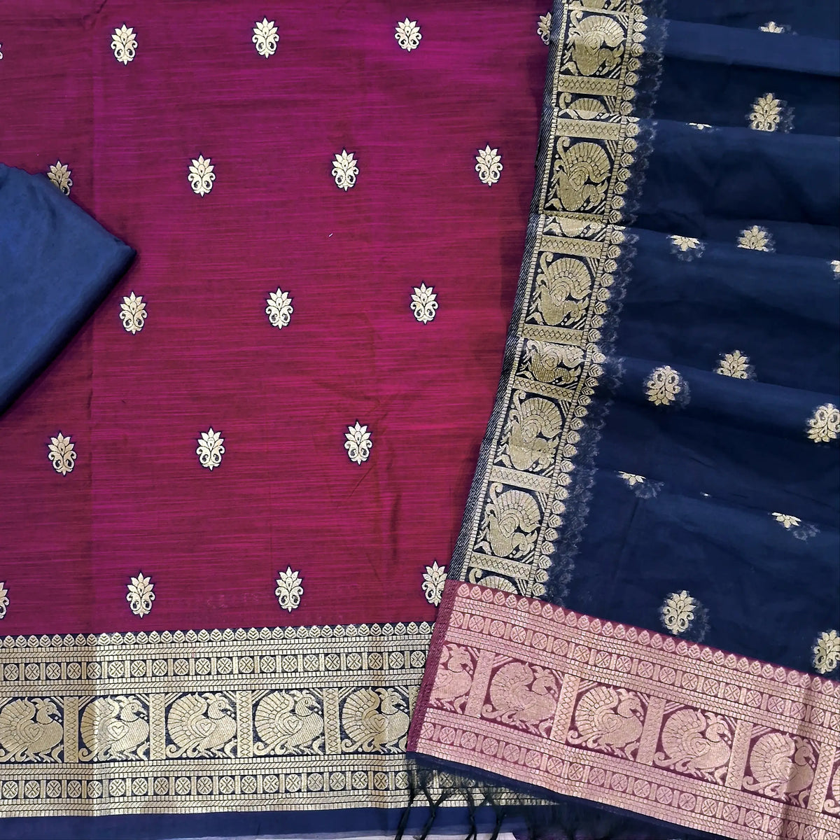 Rani pink premium silk cotton unstitched salwar material,buttas all over benarasi zari weaving daman, (lining needed)dark blue silky bottom,buttas on silk cotton dupatta with pallu and borders. SP261804