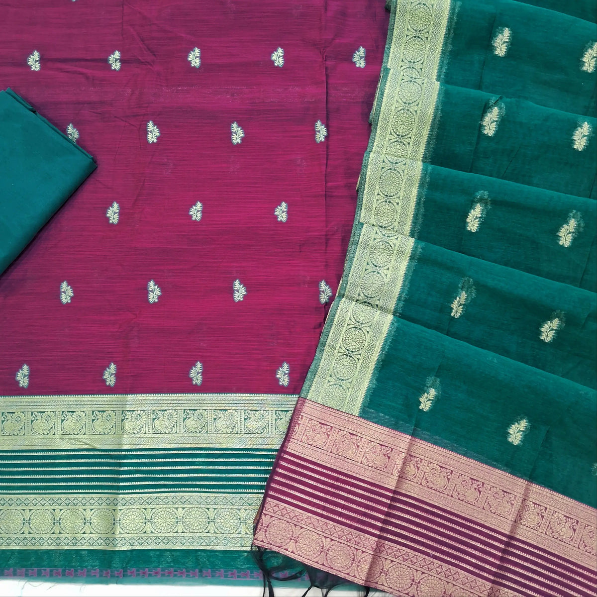 Rani pink premium silk cotton unstitched salwar material,buttas all over benarasi zari weaving daman, (lining needed)peacock green silky bottom,buttas on silk cotton dupatta with contrast pallu and borders. SP262205