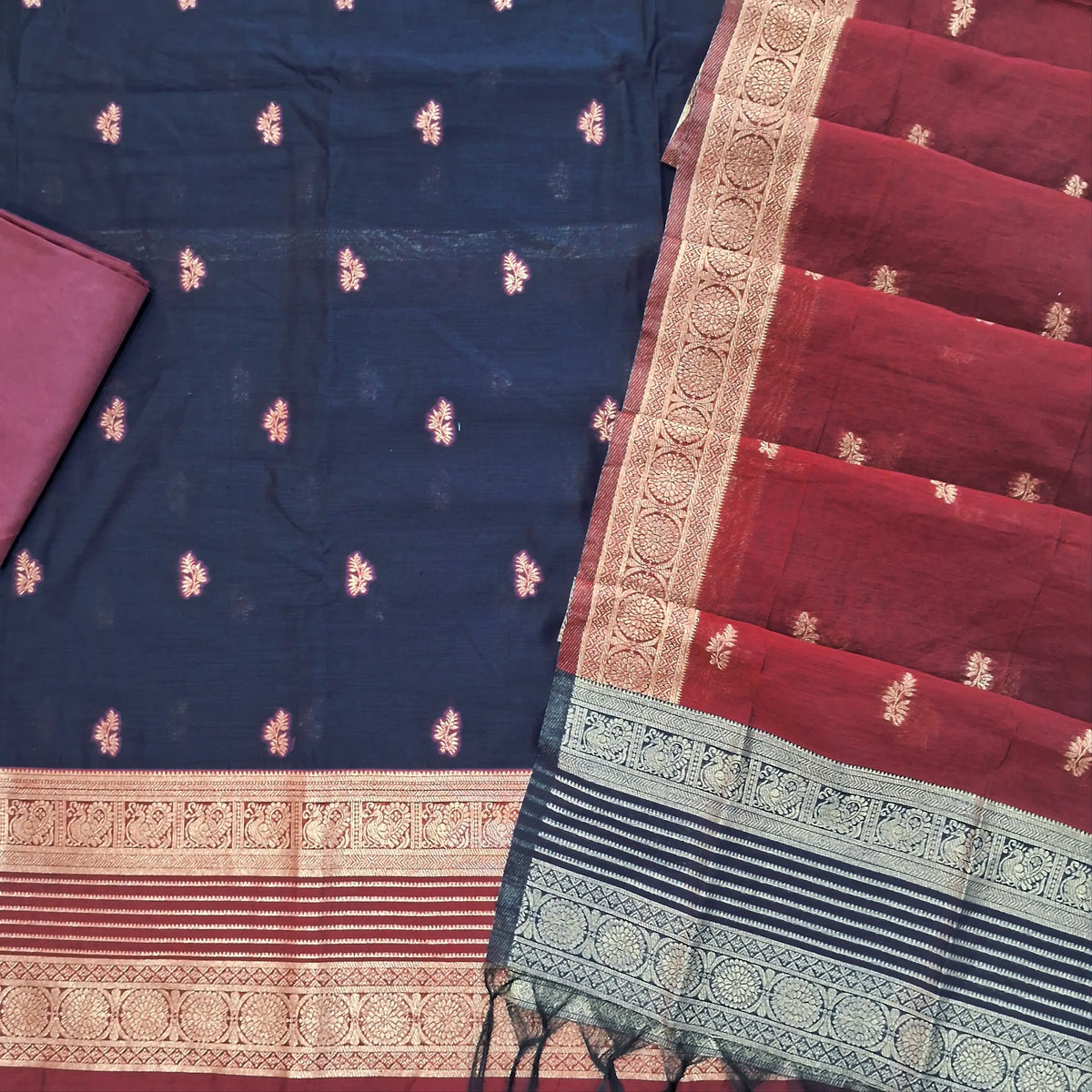 Dark blue premium silk cotton unstitched salwar material,buttas all over benarasi zari weaving daman, (lining needed)maroon silky bottom,buttas on silk cotton dupatta with contrast pallu and borders. SP262206