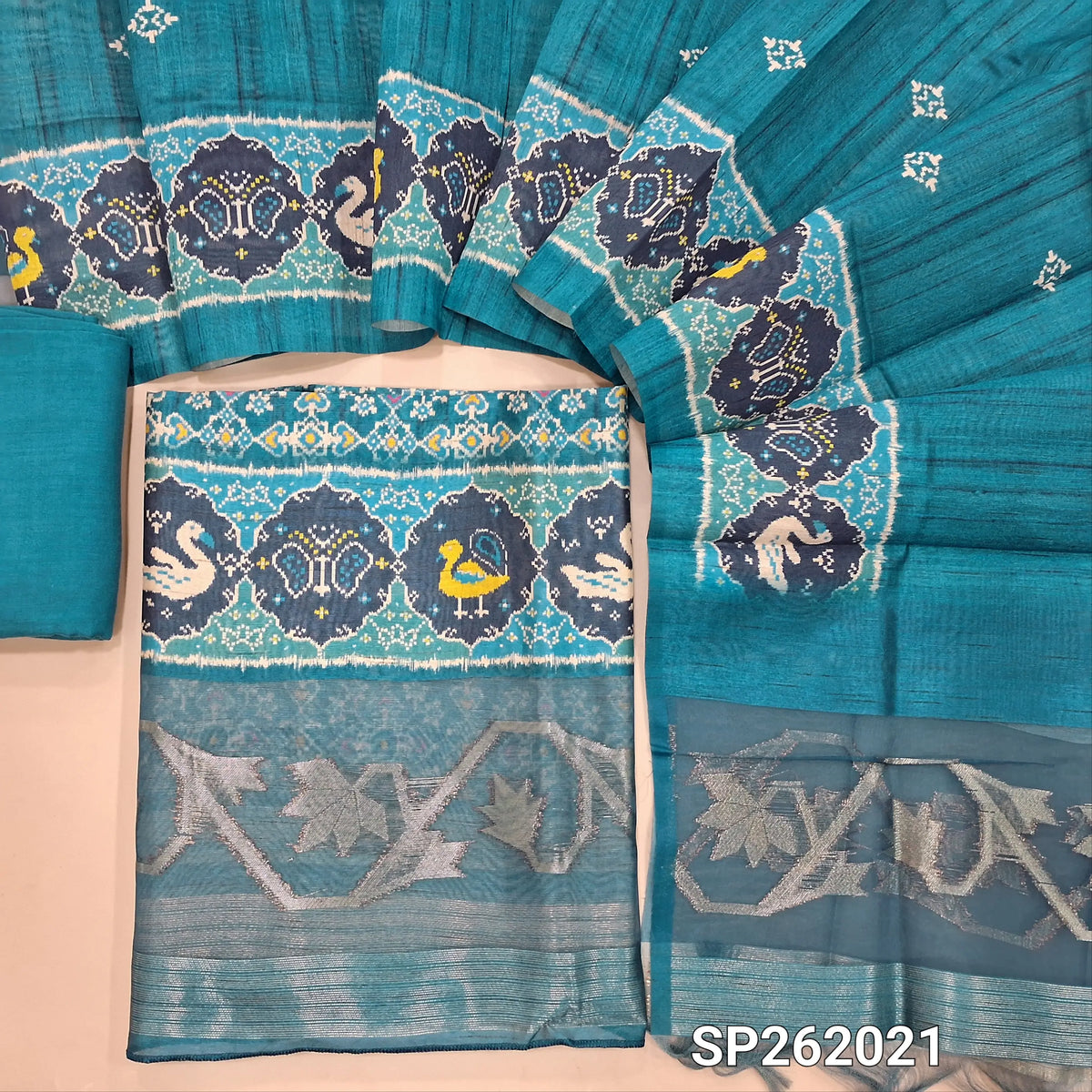 Blue patola printed semi tussar unstitched salwar material(lining needed) zari woven organza daman, matching santoon bottom, printed full length tussar silk dupatta with organza pallu with zari weaving. SP262021