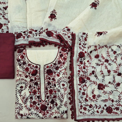 Off white base silk cotton unstitched salwar material,heavy hand embroidery work on front,(EMBROIDERY PATTERN MIGHT VARY)(lining needed) dark maroon spun cotton bottom,silk cotton dupatta with rich pallu and borders with pom pom tapping. SP262118