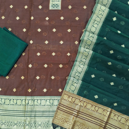 Dark brown silk cotton unstitched salwar material,benarasi zari weaving on front, rich weaving daman,(lining needed)teal green silky bottom, zari weaving on silk cotton dupatta with contrast pallu and zari borders. SP262112