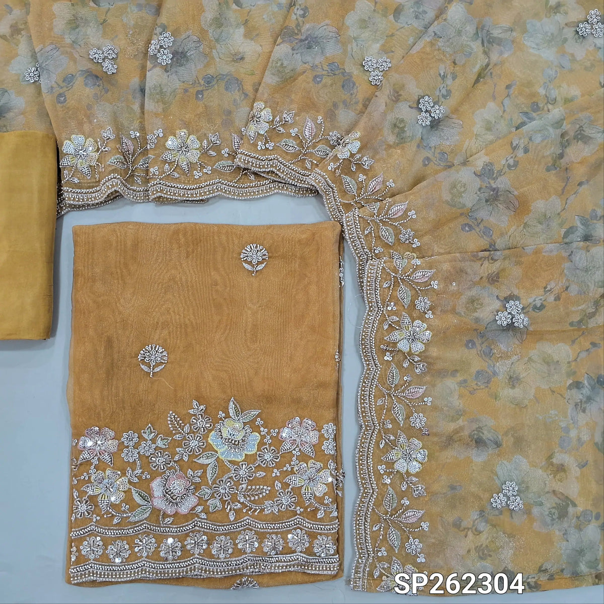 Golden yellow pure tissue organza silk digital printed unstitched salwar material, rich zardosi, cut bead ad sequins detailing on front and daman (Thin, Lining Needed)matching santoon bottom,dupatta with digital prints and rich bead detailing. SP262304