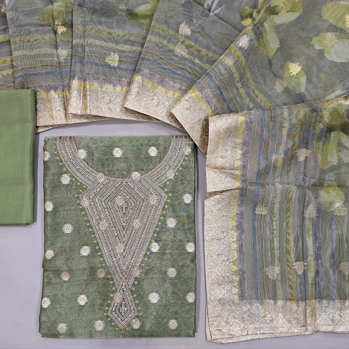 CODE MR243102 : Light olive green with golden tint designer jakard tissue silk cotton unstitched salwar material,rich work on yoke,zari woven buttas on front(thin,lining needed)matching silky bottom,tissue silk cotton duaptta with zari woven borders.