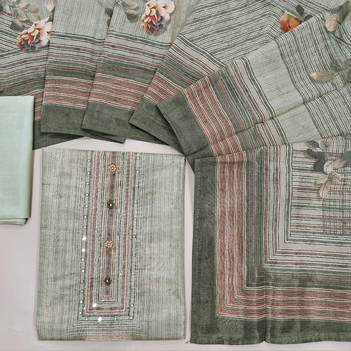 Pale green with golden tint digital printed tissue silk cotton unstitched salwar material, faux mirror& sequins work on yoke(thin fabric, lining needed)matching silky bottom, digital printed tissue silk cotton dupatta. CODE SP242826
