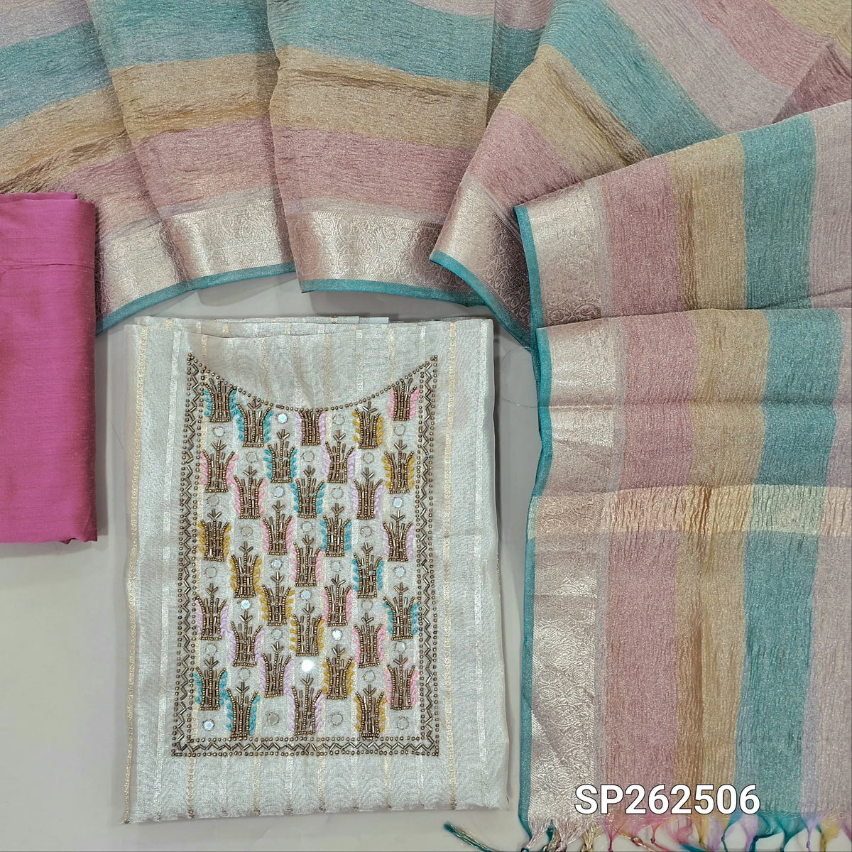 Light beige tissue silk cotton unstitched salwar material,cut bead, sugar bead and thread work on yoke,gold & silver zari weaving(lining needed)pink silk cotton bottom,multicoloured crinkled tissue silk cotton dupatta. SP262506