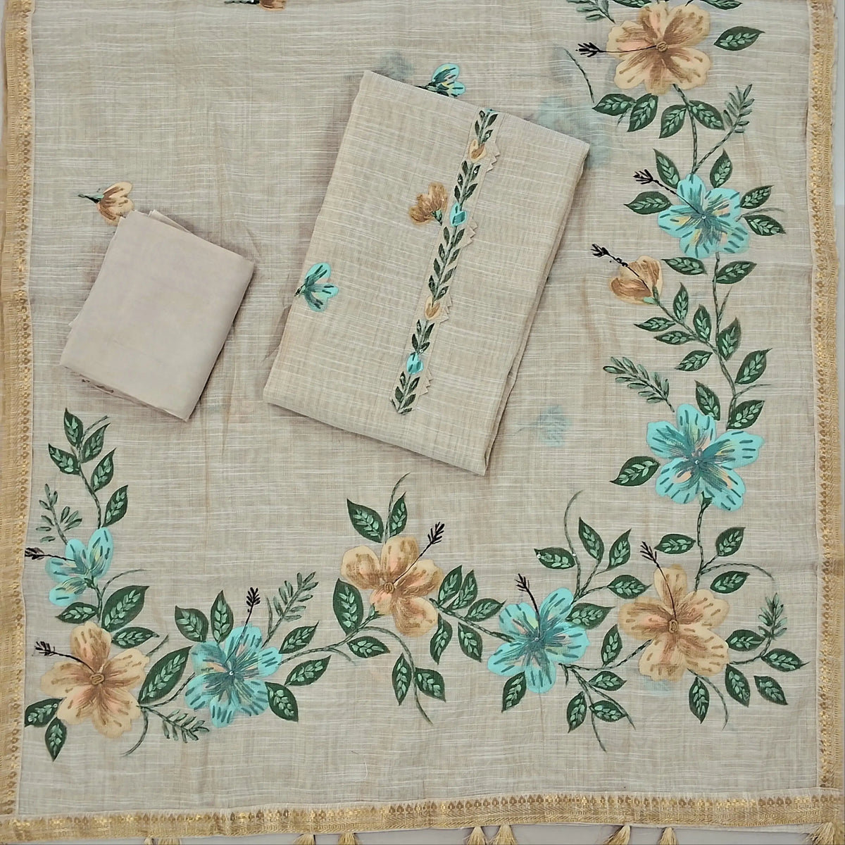 Rich beige with golden tint pure tissue linen unstitched salwar material,printed yoke with hand embroidery, brush paint on front, (lining needed)santoon bottom,(BLUE)brush painted and hand embroidery on  tissue linen dupatta with zari borders. SP262608