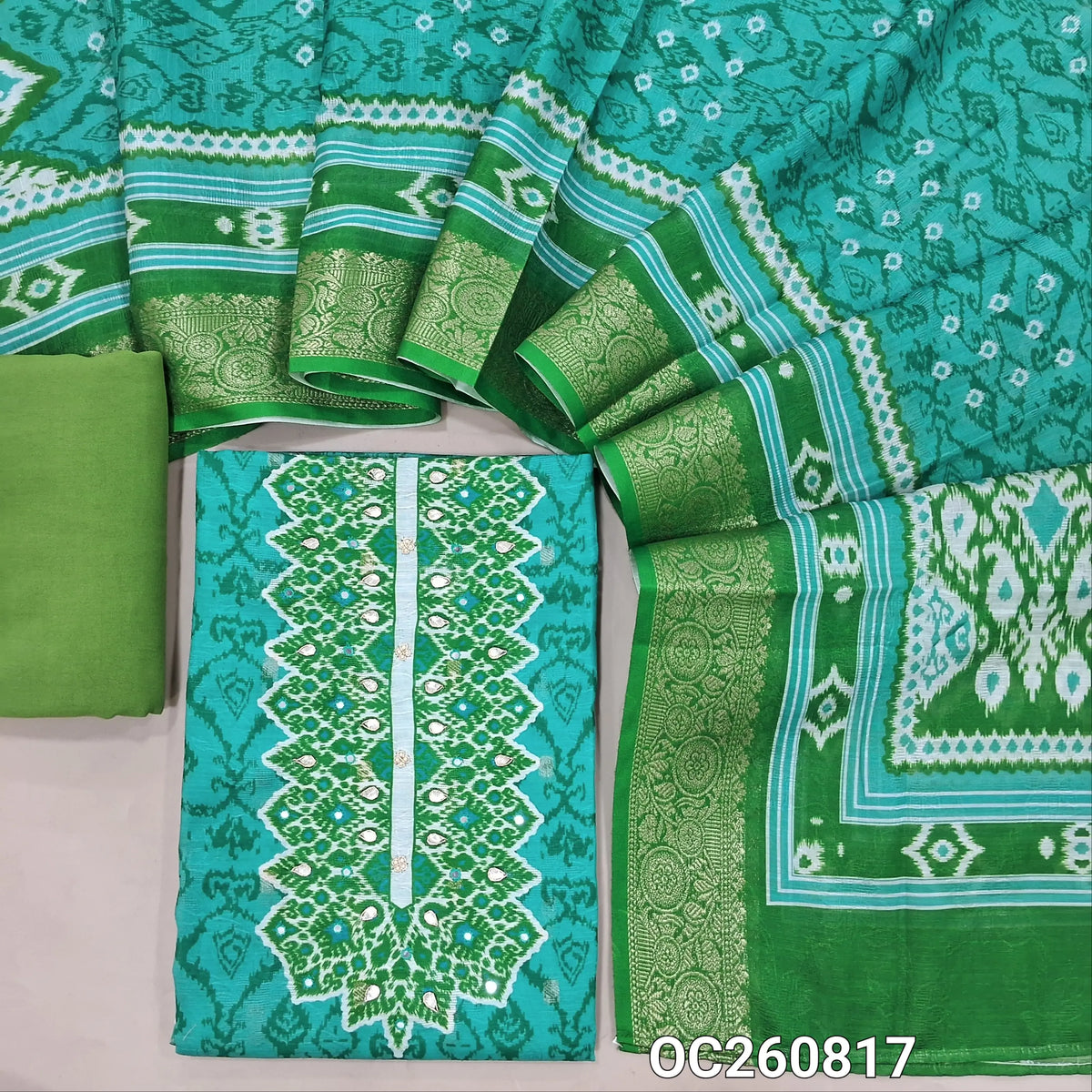 Turquoise green jakard silk cotton unstitched salwar material,contrast yoke with zardozi, printed & self design all over,printed daman,(lining needed)green spun cotton bottom, bandhini printed jakard silk cotton dupatta & rich zari woven borders. OC260817