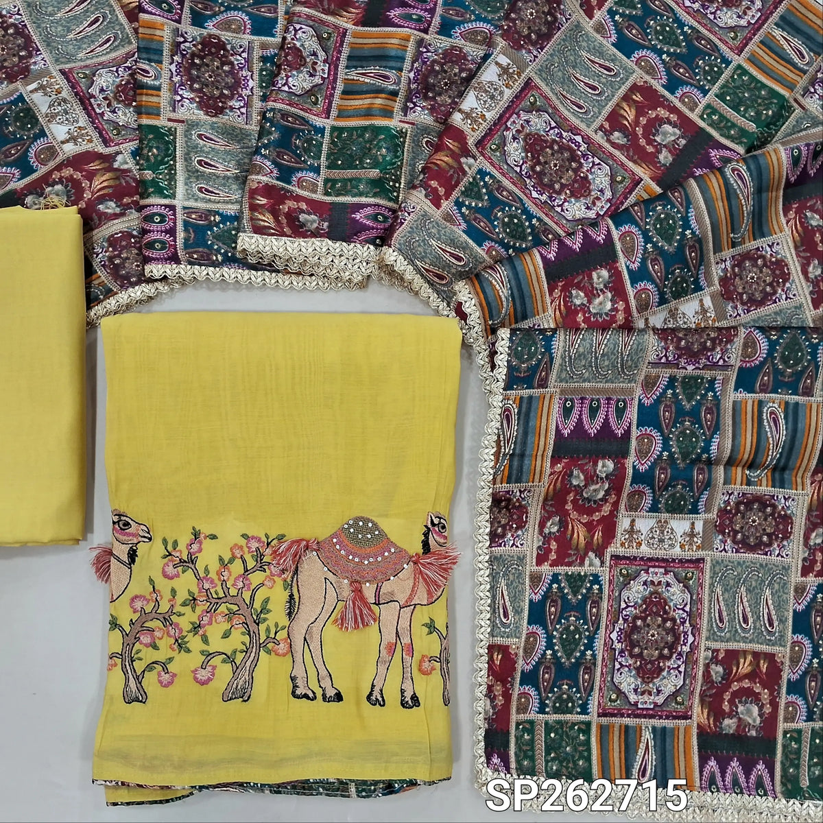 Pastel yellow mul chanderi unstitched salwar material,printed taping & tassles on yoke,camel design with embroidery work on daman,( lining needed)silk cotton bottom, multicoloured digital printed crinkled chinon silk dupatta with lace tapping. SP262715