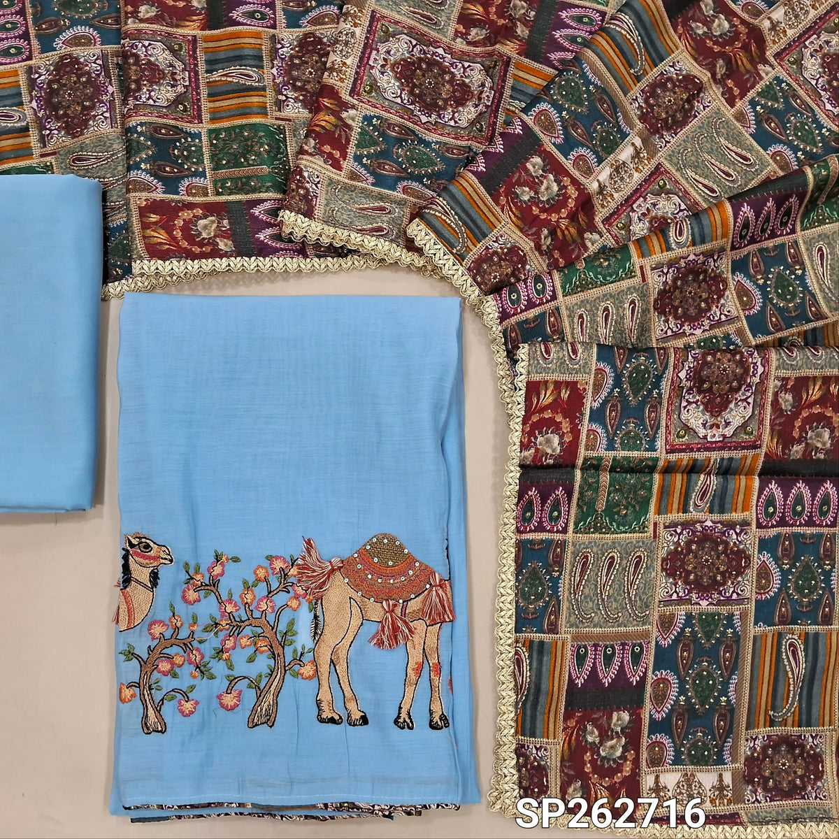 Powder blue mul chanderi unstitched salwar material,printed taping & tassles on yoke,camel design with embroidery work on daman,( lining needed)silk cotton bottom, multicoloured digital printed crinkled chinon silk dupatta with lace tapping. SP262716