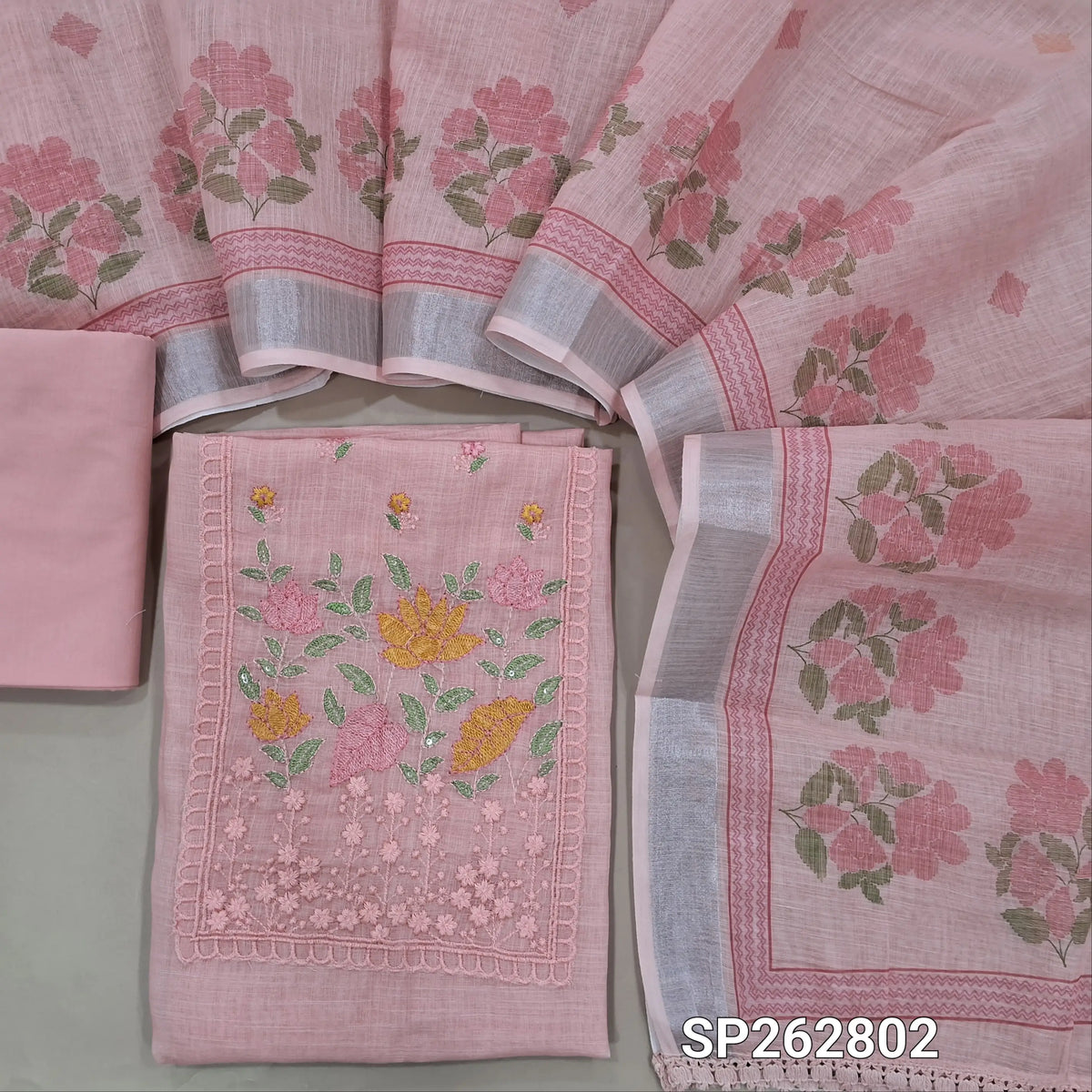 Pastel pink premium semi linen unstitched salwar material,thread embroidery work on yoke, floral printed on daman(lining needed) cotton bottom,floral printed premium semi linen dupatta with silver tissue borders. SP262802