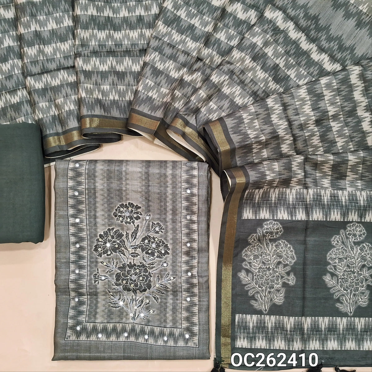 Grey semi gicha unstitched salwar material, floral design with faux miror and thread work on yoke,(thin fabric, lining needed)spun cotton bottom, digital printed semi gicha dupatta with tissue borders. OC262410