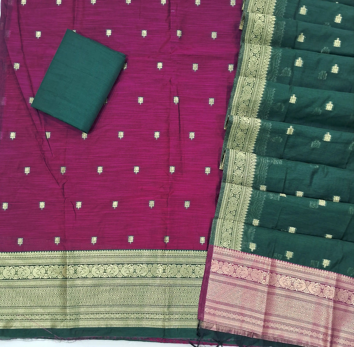 Rani pink premium silk cotton unstitched salwar material,buttas all over benarasi zari weaving daman, (lining needed)bottle green  silky bottom,buttas on dual shaded silk cotton dupatta with rich pallu and borders. SP262916